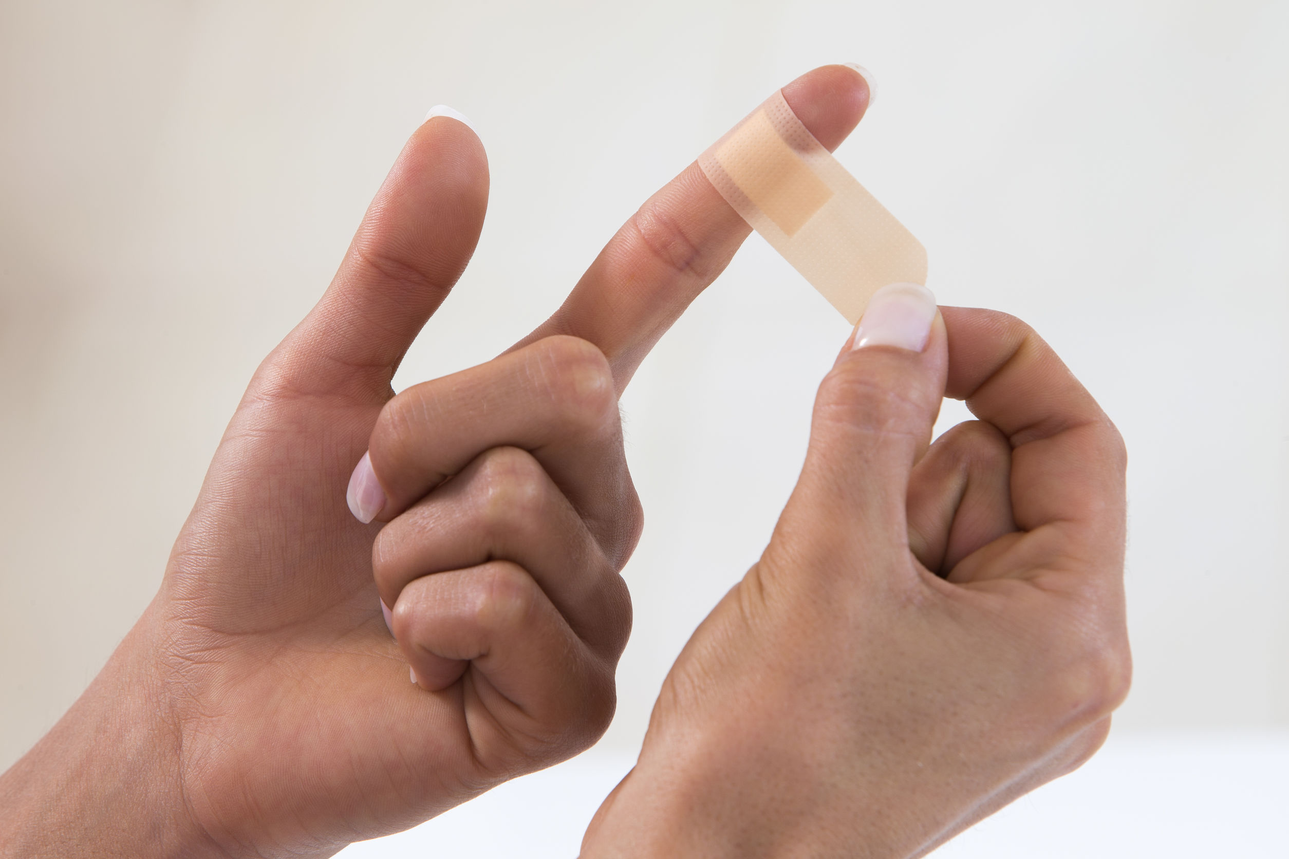 putting-bandage-on-hand-finger-family-medical-practice-urgent-care